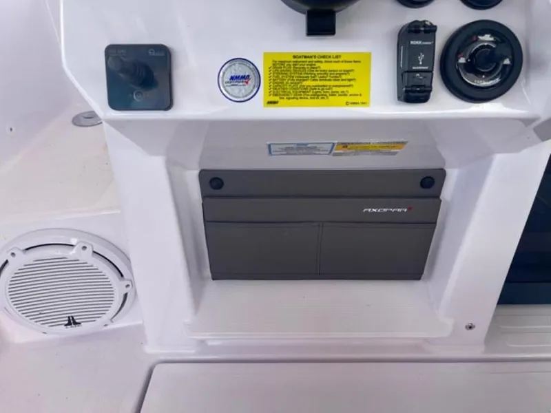 Slide: The Image of 2024 Axopar 25 Cross Top dashboard with controls and speaker. - 21