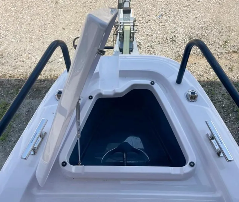 Slide: The Image of 2024 Axopar 25 Cross Top boat anchor storage compartment open. - 5