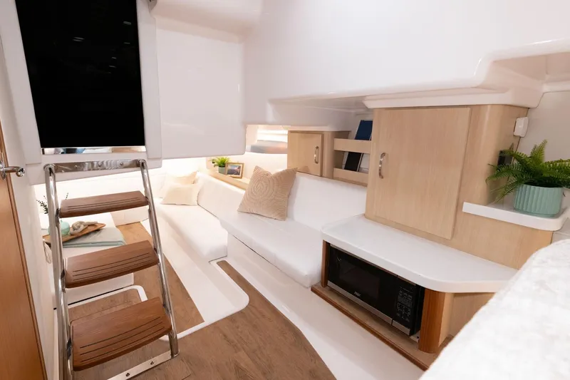 Slide: The Image of Manufacturer Provided Image: Interior of 2026 Regal 36 Grande Coupe, featuring modern design with cozy seating and wooden accents. - 14