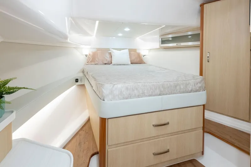 Slide: The Image of Manufacturer Provided Image: Luxurious cabin interior of 2026 Regal 36 Grande Coupe yacht with bed and storage. - 16