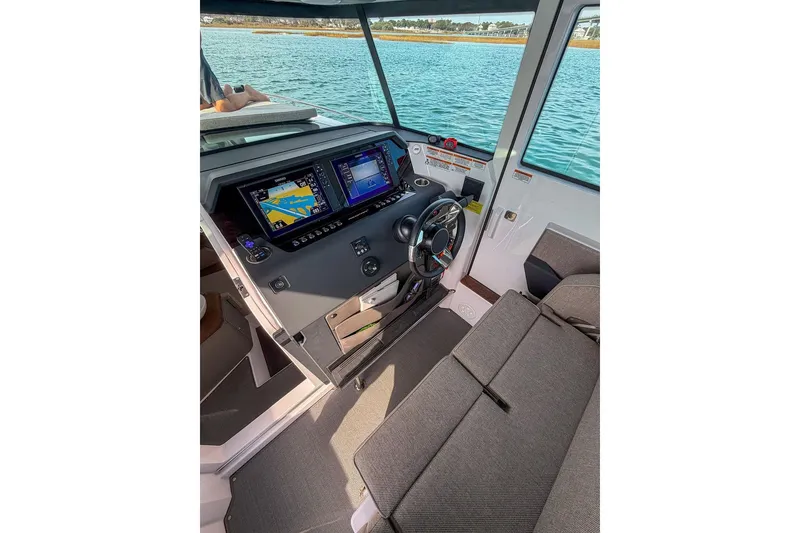 Slide: The Image of 2023 Axopar 37 XC Cross Cabin interior with modern navigation system and comfortable seating. - 11