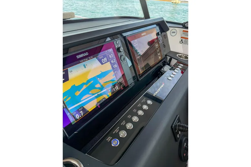 Slide: The Image of 2023 Axopar 37 XC Cross Cabin dashboard with Simrad navigation displays. - 12