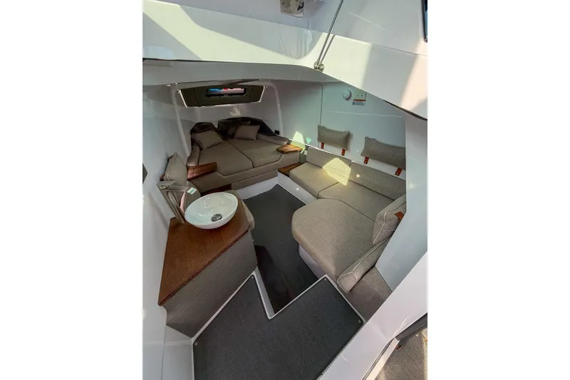 Slide: The Image of 2023 Axopar 37 XC Cross Cabin interior with cozy seating and modern design. - 13