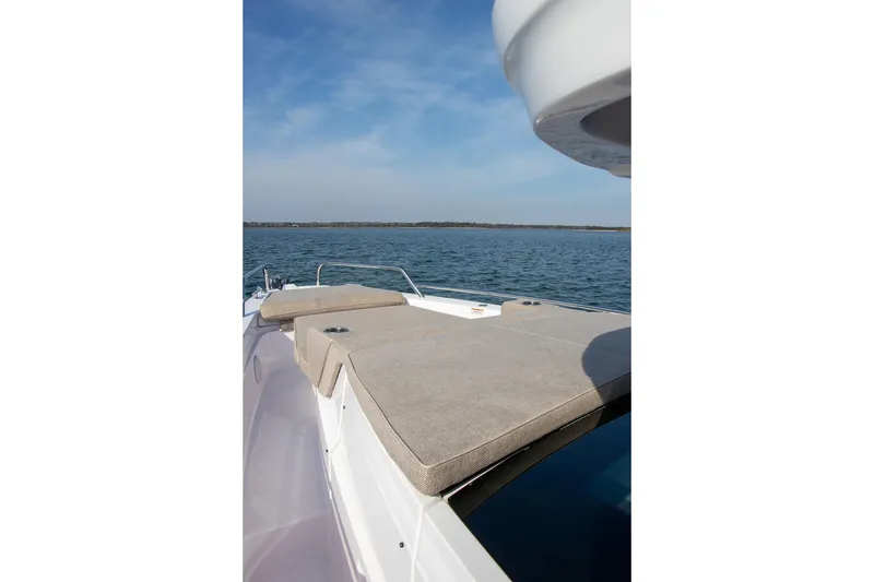 Slide: The Image of 2023 Axopar 37 XC Cross Cabin boat with sun deck on calm water. - 9