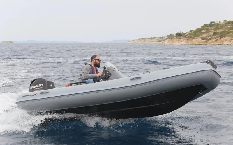 Slide: The Image of 2024 Northstar Axis 4.2 inflatable boat cruising on the ocean. - 2