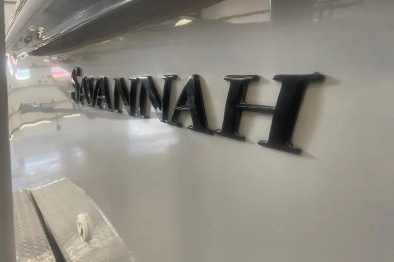 Slide: The Image of Close-up of 2023 Savannah SS21 boat nameplate in sleek black lettering. - 10