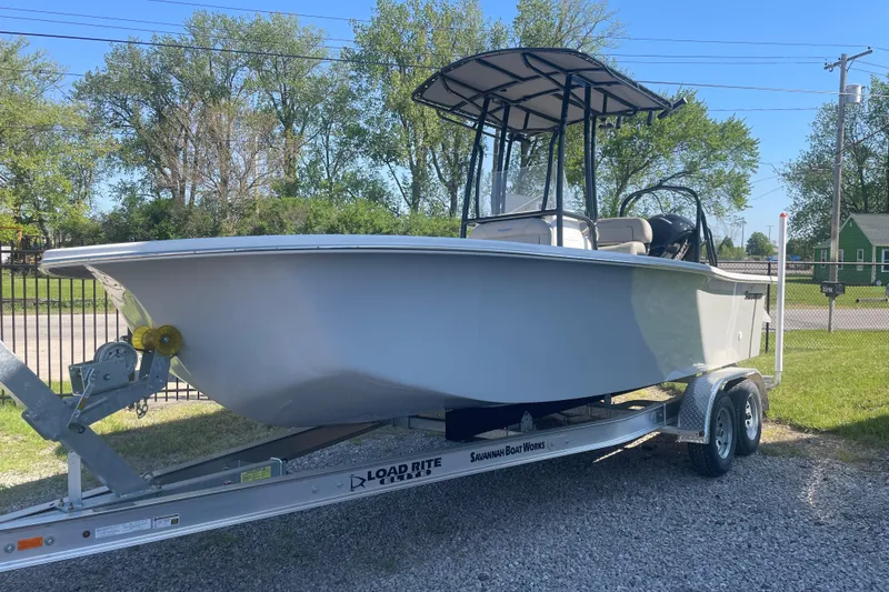 Slide: The Image of 2023 Savannah SS21 boat on trailer, parked outdoors, sunny day. - 11