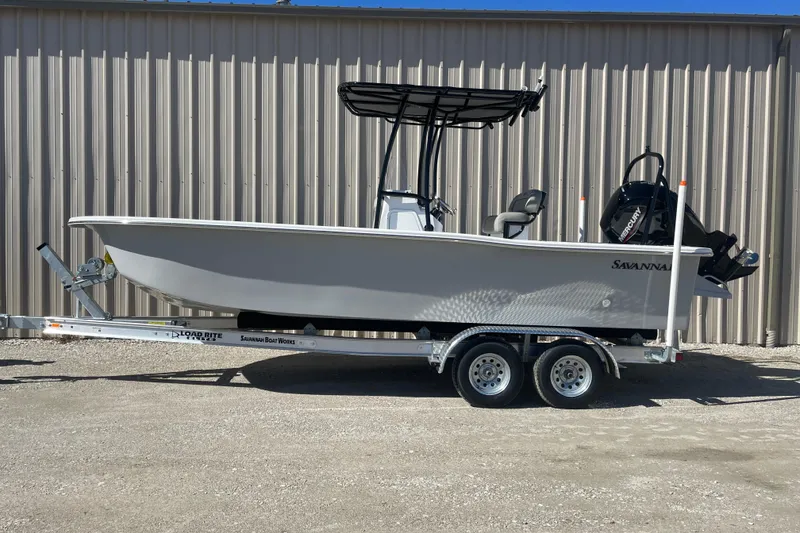 Slide: The Image of 2023 Savannah SS21 boat on trailer, parked outdoors, side view. - 12