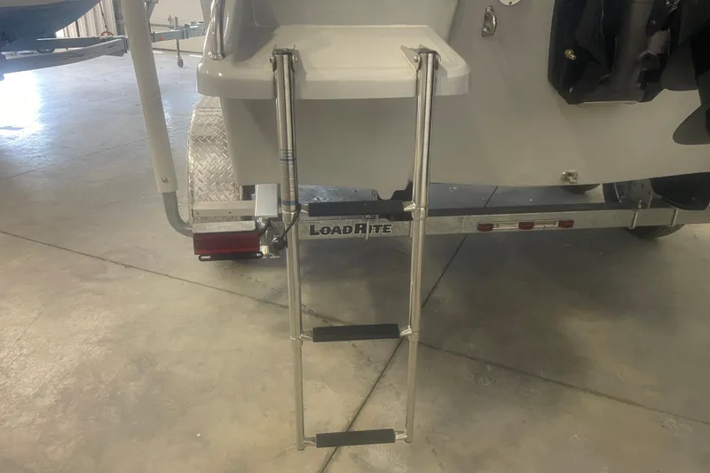 Slide: The Image of Rear view of 2023 Savannah SS21 boat with Load Rite trailer and foldable ladder. - 9