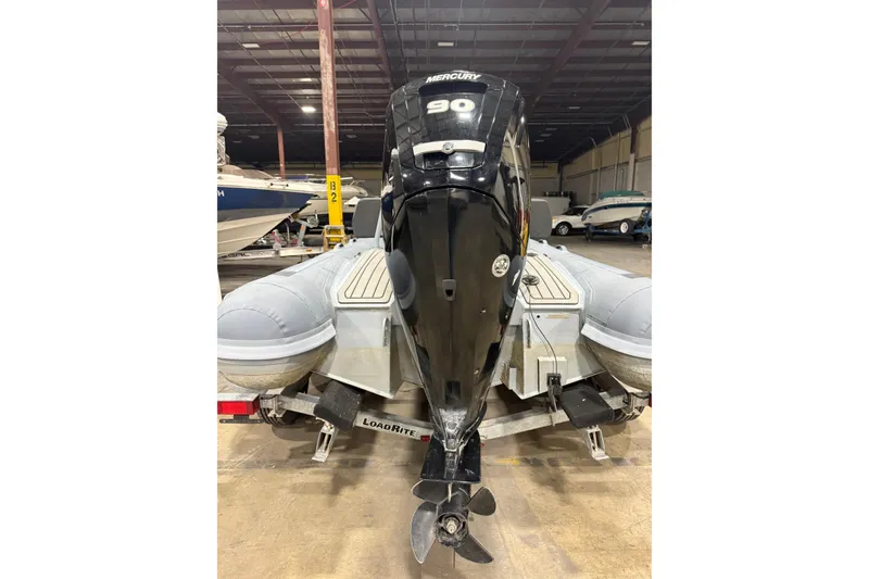 Slide: The Image of 2022 Highfield Sport 460 boat with Mercury 90 engine on Load Rite trailer in warehouse. - 3