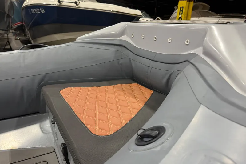 Slide: The Image of 2022 Highfield Sport 460 boat interior with cushioned seating and sleek design. - 7