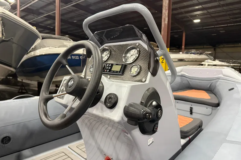 Slide: The Image of 2022 Highfield Sport 460 boat interior with steering wheel and control panel. - 9