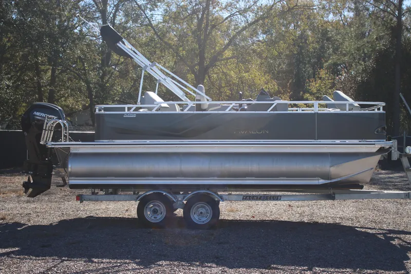 Slide: The Image of 2026 Avalon VENTURE 85 QUAD pontoon boat on trailer, parked outdoors. - 2