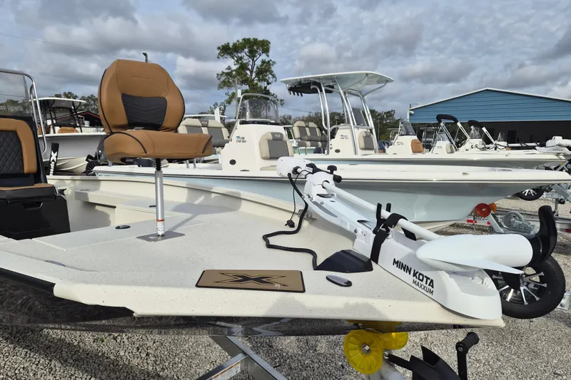 Slide: The Image of 2026 Xpress H22B Bay boat with Minn Kota Maxxum motor in a marina setting. - 4