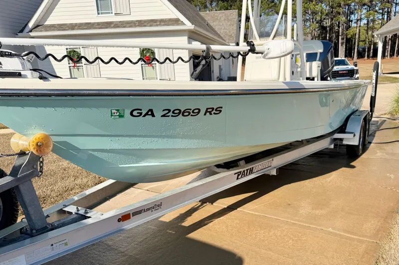 Slide: The Image of 2015 Pathfinder 2400 TRS boat on trailer, parked in residential driveway. - 2
