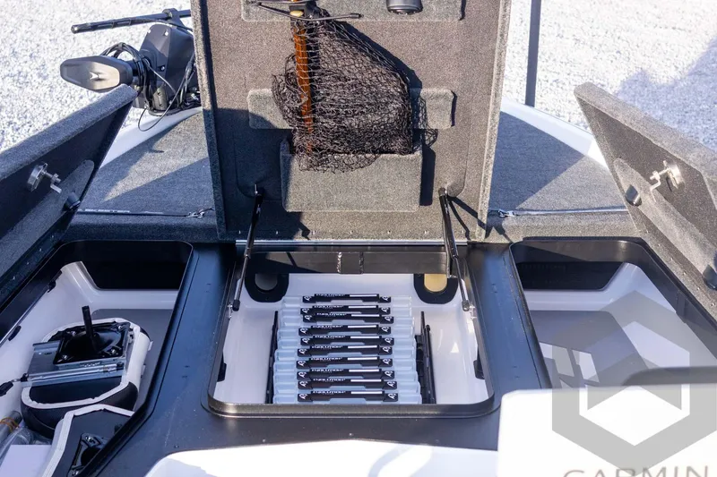 Slide: The Image of Open storage compartments on a 2026 Skeeter FXR21 FLEX boat, featuring organized fishing gear. - 26