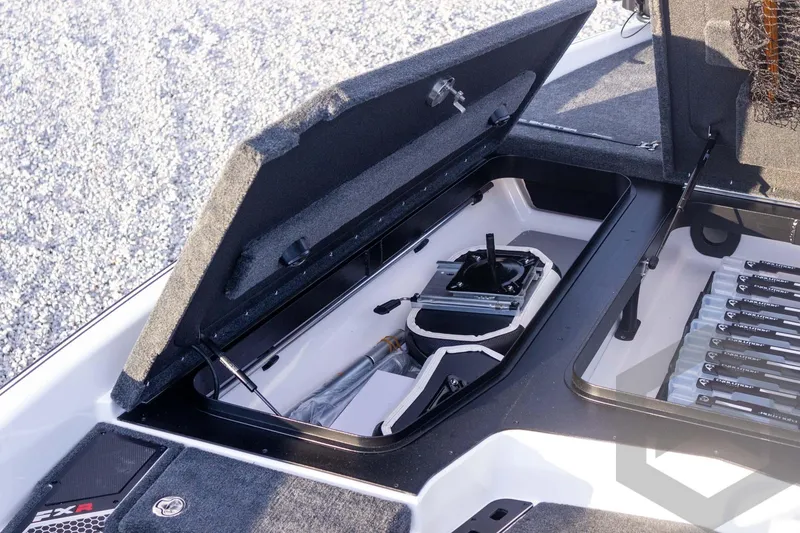 Slide: The Image of 2026 Skeeter FXR21 FLEX boat storage compartment with organized equipment and gear. - 27