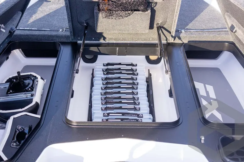 Slide: The Image of 2026 Skeeter FXR21 FLEX boat storage compartment with organized fishing gear. - 28