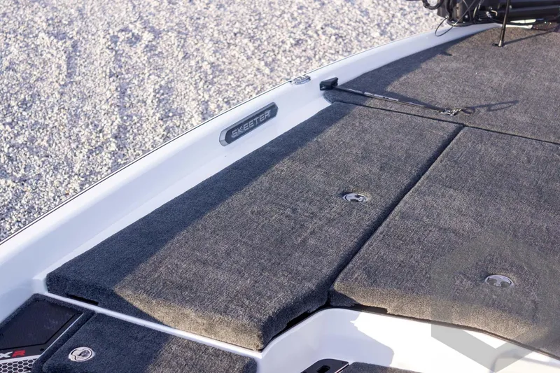 Slide: The Image of 2026 Skeeter FXR21 FLEX boat deck with gray carpet and storage compartments. - 30