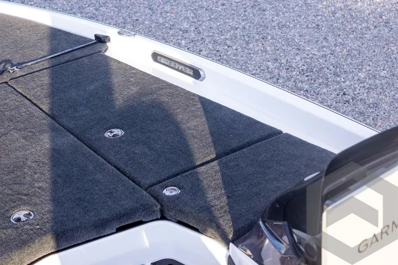 Slide: The Image of 2026 Skeeter FXR21 FLEX boat deck with carpeted surface and storage compartments. - 32