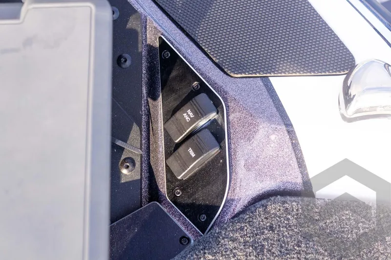 Slide: The Image of Control panel of 2026 Skeeter FXR21 FLEX boat with navigation and trim switches. - 35