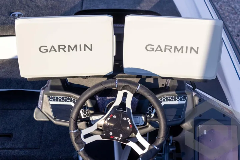 Slide: The Image of 2026 Skeeter FXR21 FLEX boat dashboard with dual Garmin displays and steering wheel. - 41