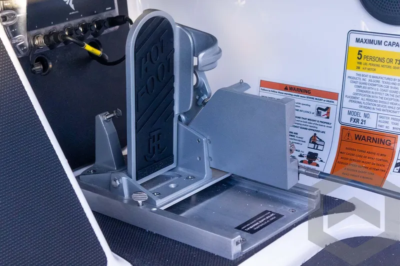 Slide: The Image of 2026 Skeeter FXR21 FLEX boat foot pedal and warning labels. - 44