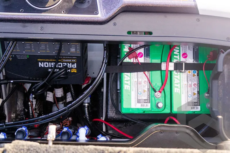 Slide: The Image of Battery compartment of 2026 Skeeter FXR21 FLEX boat with Interstate batteries and charger. - 54