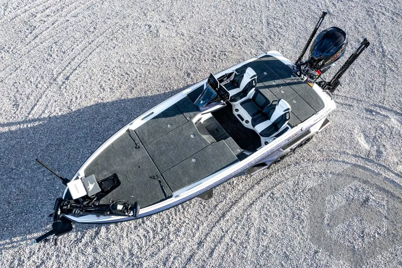 Slide: The Image of 2026 Skeeter FXR21 FLEX fishing boat on gravel surface, aerial view. - 59