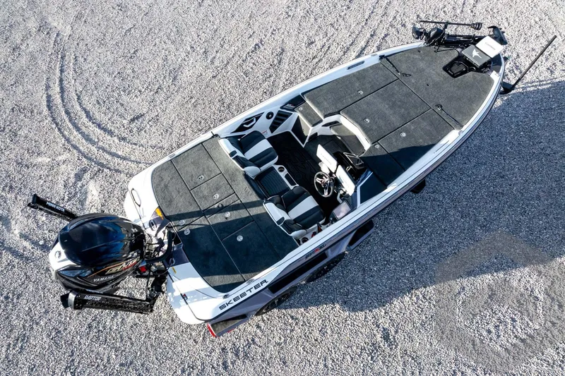Slide: The Image of 2026 Skeeter FXR21 FLEX boat on gravel, top view, showcasing sleek design and spacious interior. - 63
