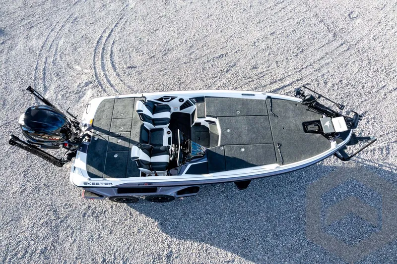 Slide: The Image of 2026 Skeeter FXR21 FLEX boat on gravel, top view, showcasing seating and deck layout. - 64