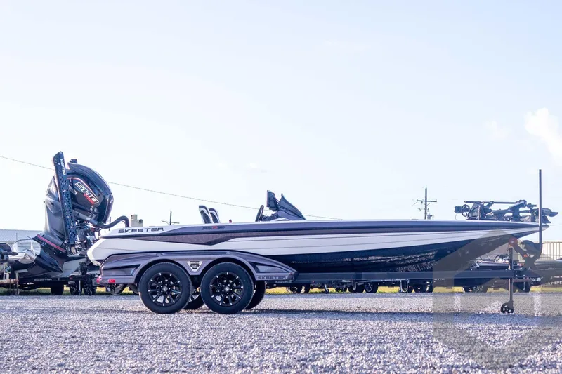 Slide: The Image of 2026 Skeeter FXR21 FLEX boat on trailer, side view, outdoors. - 8