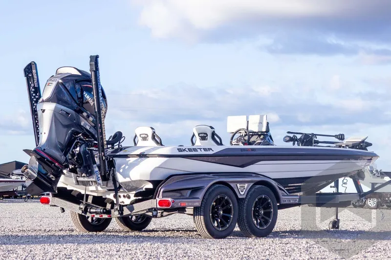 Slide: The Image of 2026 Skeeter FXR21 FLEX boat on trailer, featuring Yamaha engine, parked on gravel. - 9