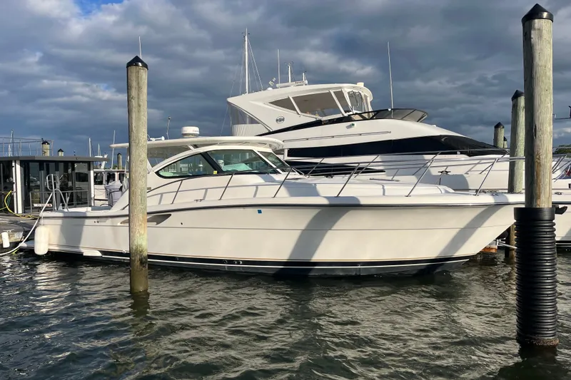 The Image of 2004 Tiara Yachts 3800 Open docked at marina under cloudy sky. - 0