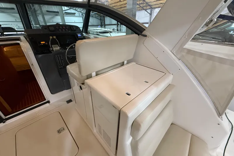 Slide: The Image of 2004 Tiara Yachts 3800 Open in storage, showcasing sleek deck design and metal railings. - 17