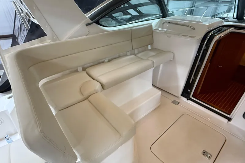 Slide: The Image of 2004 Tiara Yachts 3800 Open interior with seating, docked in a covered marina. - 20