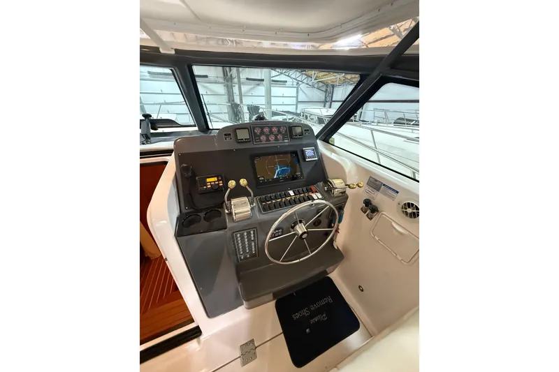 Slide: The Image of 2004 Tiara Yachts 3800 Open interior with beige seating and helm view. - 22