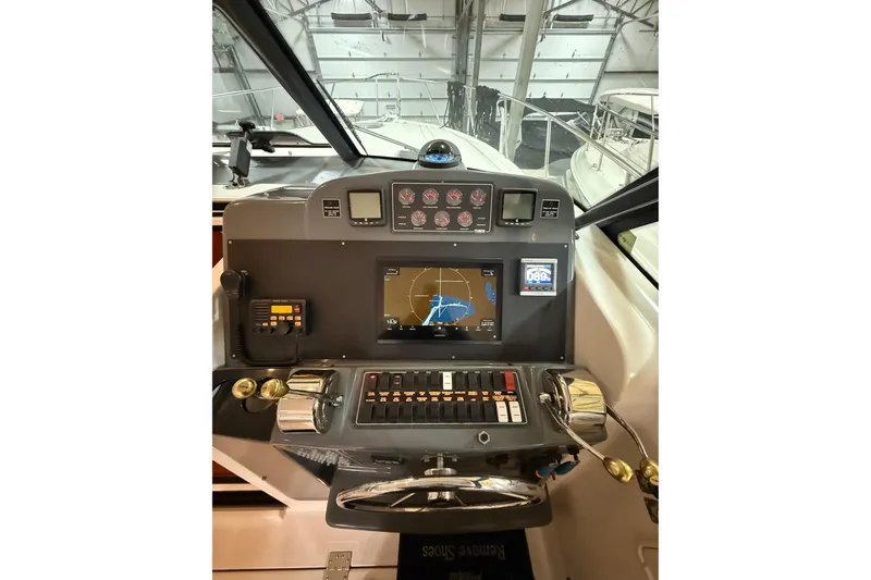 Slide: The Image of 2004 Tiara Yachts 3800 Open interior with beige seating and sleek design. - 23