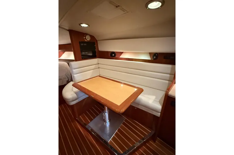 Slide: The Image of 2004 Tiara Yachts 3800 Open cockpit with white seating and storage compartments. - 27