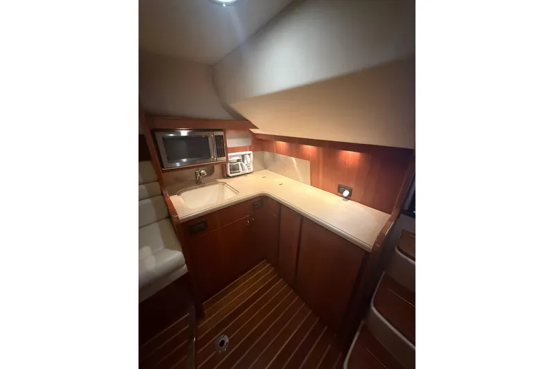 Slide: The Image of 2004 Tiara Yachts 3800 Open interior with seating and storage compartments. - 28