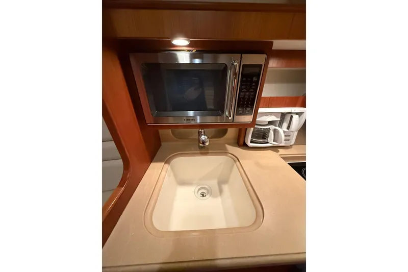 Slide: The Image of 2004 Tiara Yachts 3800 Open interior with foldable bench seat and cup holders. - 30