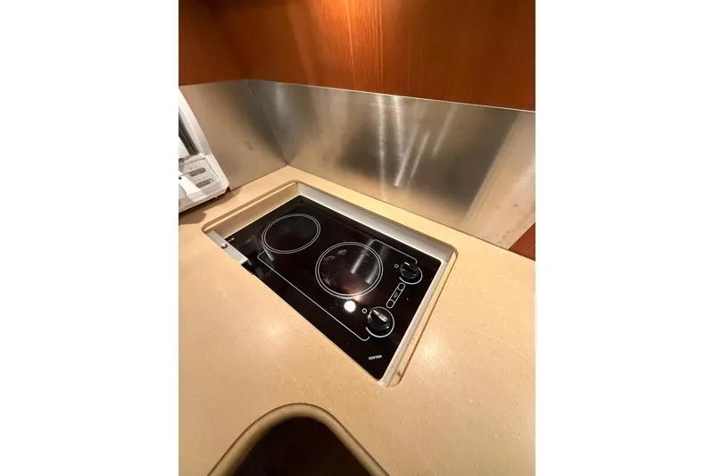 Slide: The Image of 2004 Tiara Yachts 3800 Open interior with foldable bench seat and storage compartments. - 31