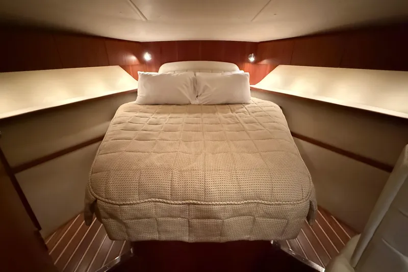 Slide: The Image of 2004 Tiara Yachts 3800 Open interior with white seating and storage compartments. - 34