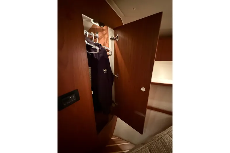 Slide: The Image of 2004 Tiara Yachts 3800 Open helm seat with white upholstery and control panel. - 38