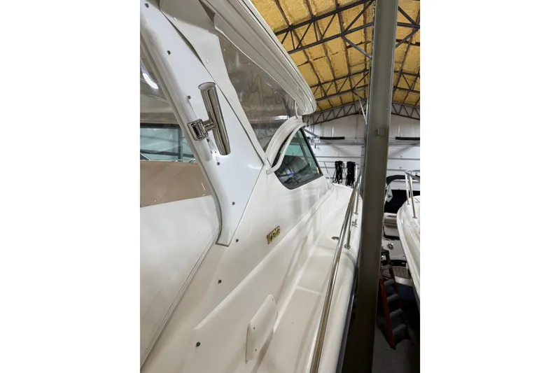 Slide: The Image of 2004 Tiara Yachts 3800 Open interior with beige seating and modern design. - 5