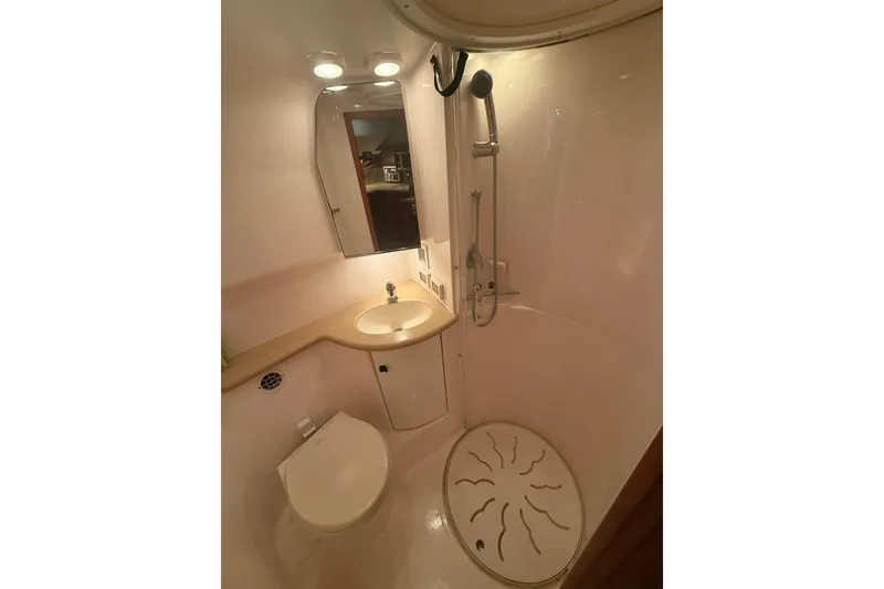 Slide: The Image of 2004 Tiara Yachts 3800 Open bathroom with shower, sink, and toilet. - 59