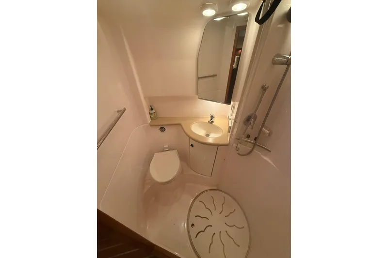 Slide: The Image of Compact bathroom in 2004 Tiara Yachts 3800 Open, featuring shower, sink, and toilet. - 60