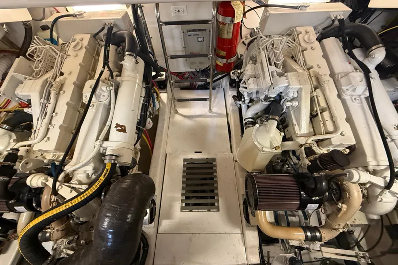 Slide: The Image of Engine room of a 2004 Tiara Yachts 3800 Open, featuring dual engines and fire extinguisher. - 64