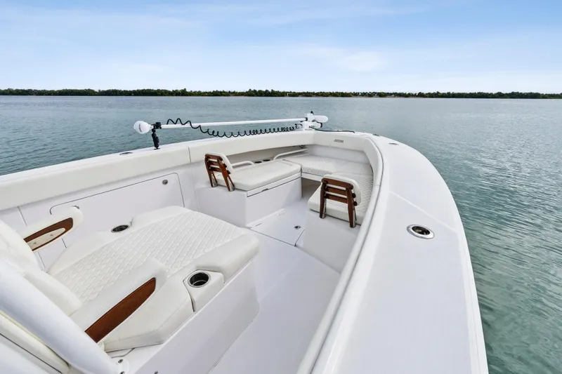 Slide: The Image of 2022 Jupiter 34 HFS boat interior with luxurious seating on calm water. - 10