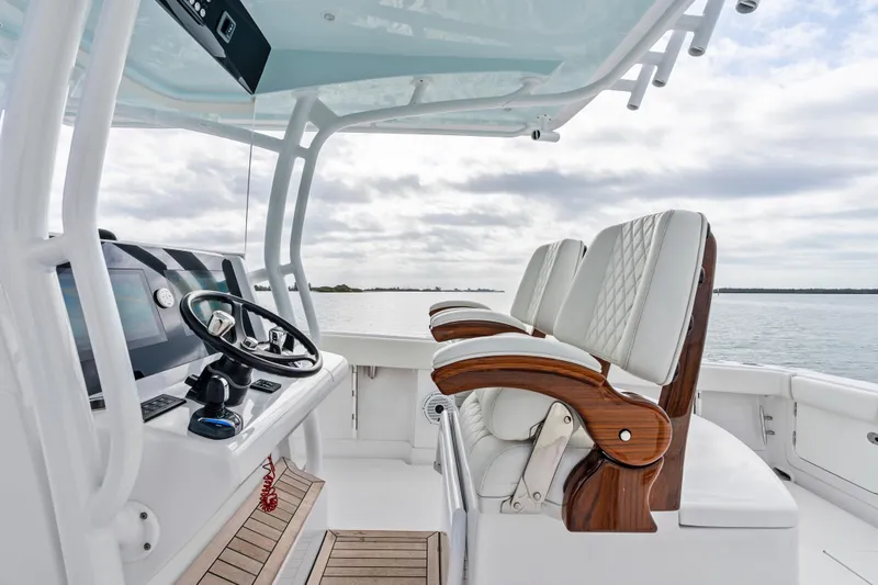 Slide: The Image of 2022 Jupiter 34 HFS boat interior with luxurious seating and modern helm controls. - 16